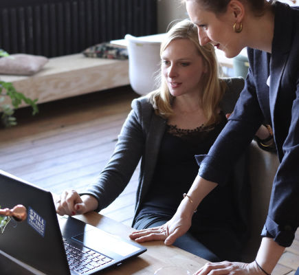 Women share knowledge on laptop